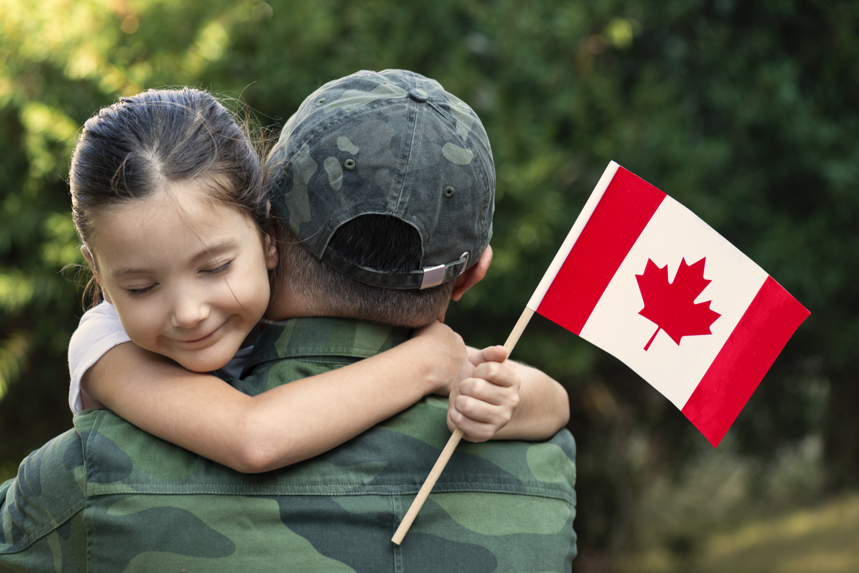 Canadian soldier and his daughter hugging each other